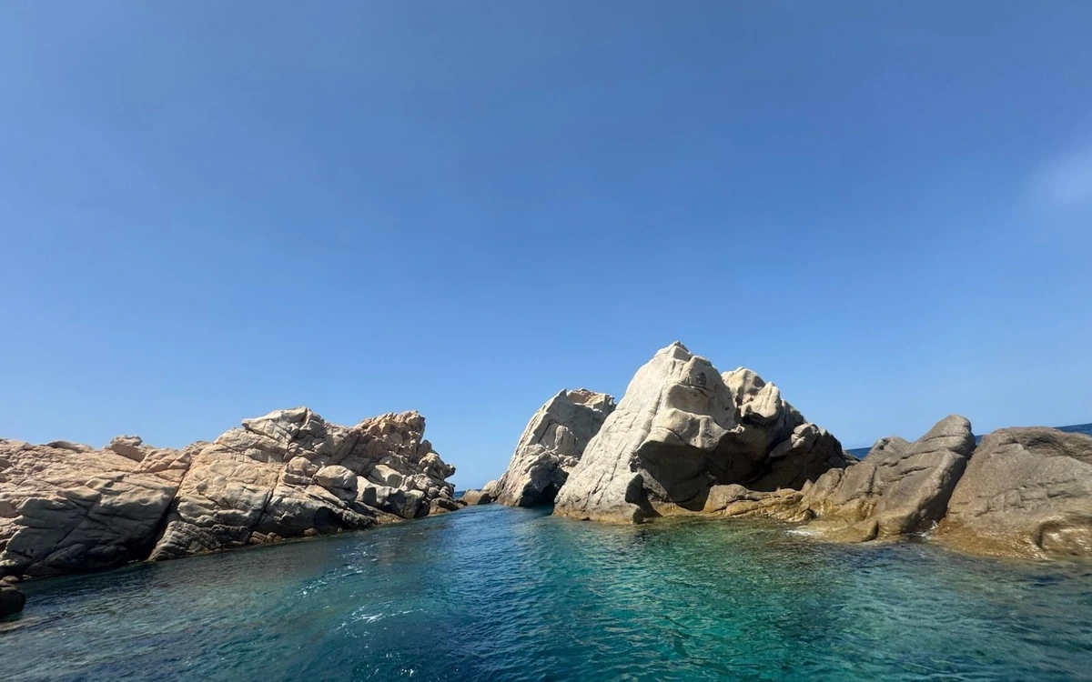 Pale granite rocks around a narrow channel of clear water